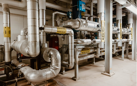 Industrial piping and valve system at Sauer Group facility.