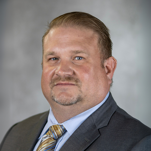 Executive portrait of Sauer Group professional in formal business attire.
