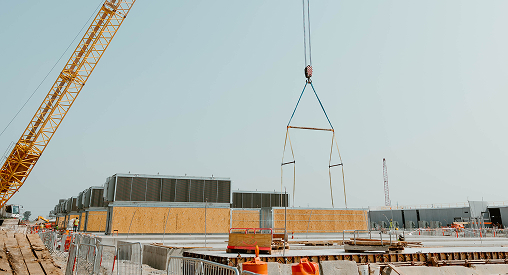 Construction site with crane and building materials in progress.