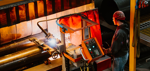 Industrial welding process at Sauer Group facility.