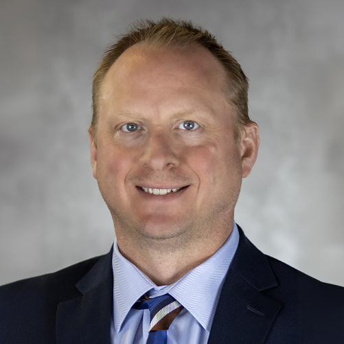 Executive portrait of Sauer Group professional in formal business attire.