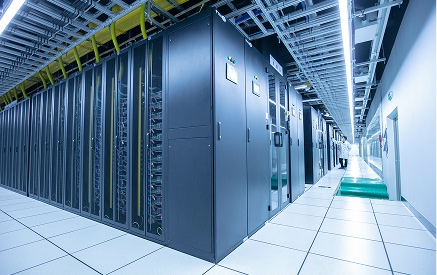 Data center server racks with networking equipment at Sauer Group.